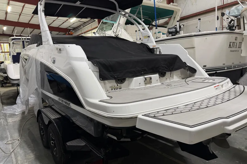 Slide: The Image of 2024 Four Winns HD5 boat in storage, showcasing sleek design and spacious deck. - 4