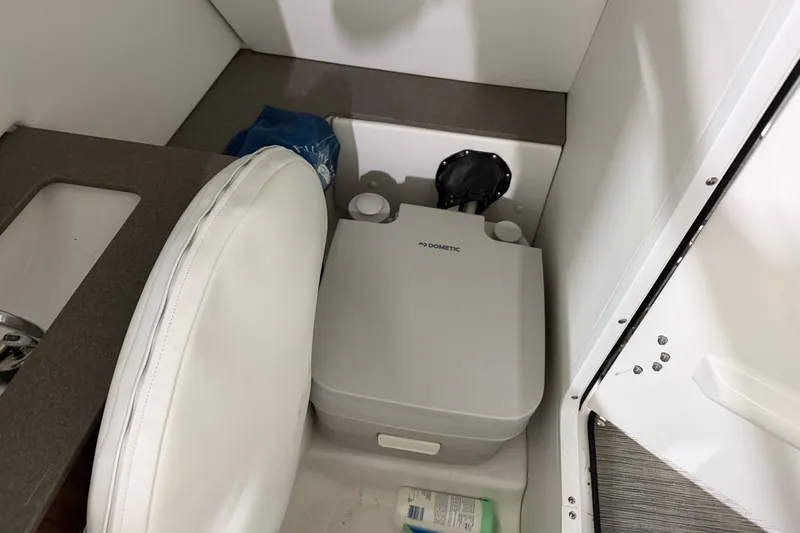 Slide: The Image of 2024 Four Winns HD5 boat interior with Dometic portable toilet. - 40