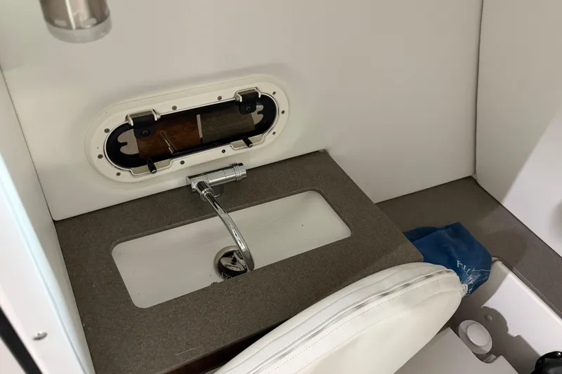 Slide: The Image of 2024 Four Winns HD5 boat interior with sink and porthole window. - 41