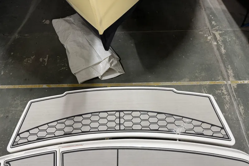 Slide: The Image of 2024 Four Winns HD5 boat deck with hexagonal pattern design. - 43