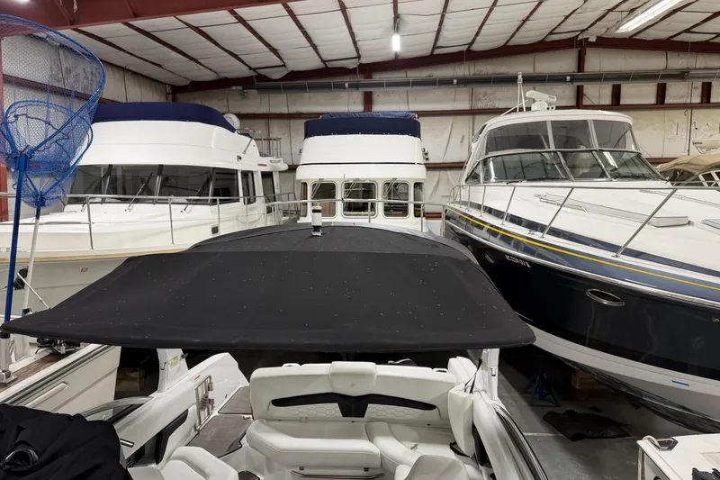 Slide: The Image of 2024 Four Winns HD5 boat in storage, surrounded by other yachts in a warehouse. - 44