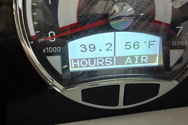 Slide: The Image of Close-up of 2024 Four Winns HD5 boat dashboard displaying 39.2 hours and 56°F air temperature. - 48