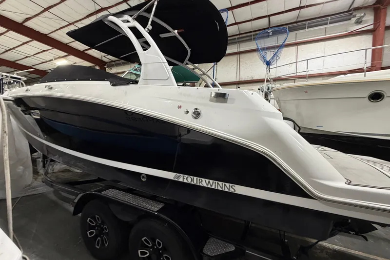 Slide: The Image of 2024 Four Winns HD5 boat in indoor storage, showcasing sleek design and modern features. - 5