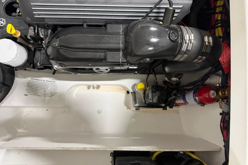 Slide: The Image of Engine compartment of 2024 Four Winns HD5 boat, featuring detailed components and wiring. - 55