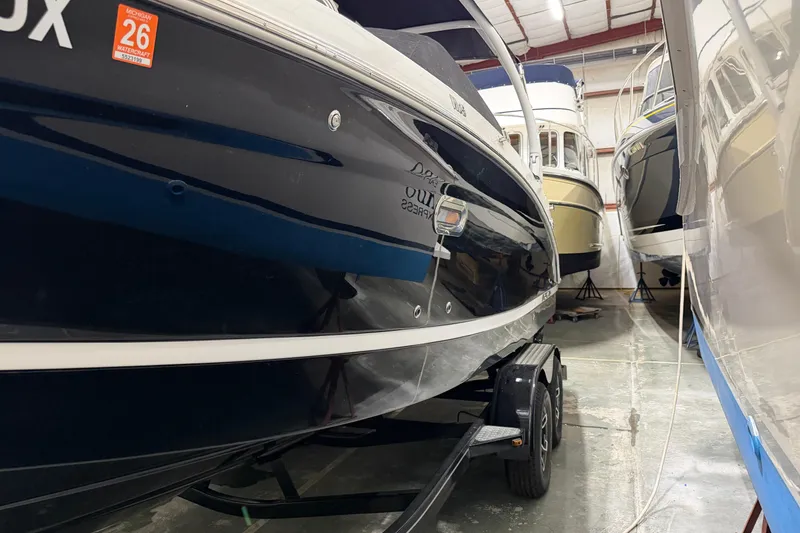 Slide: The Image of 2024 Four Winns HD5 boat in storage, side view with trailer. - 6