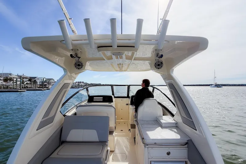 Slide: The Image of 2023 Scout 277 Dorado boat cruising on calm waters, featuring spacious seating and modern design. - 10