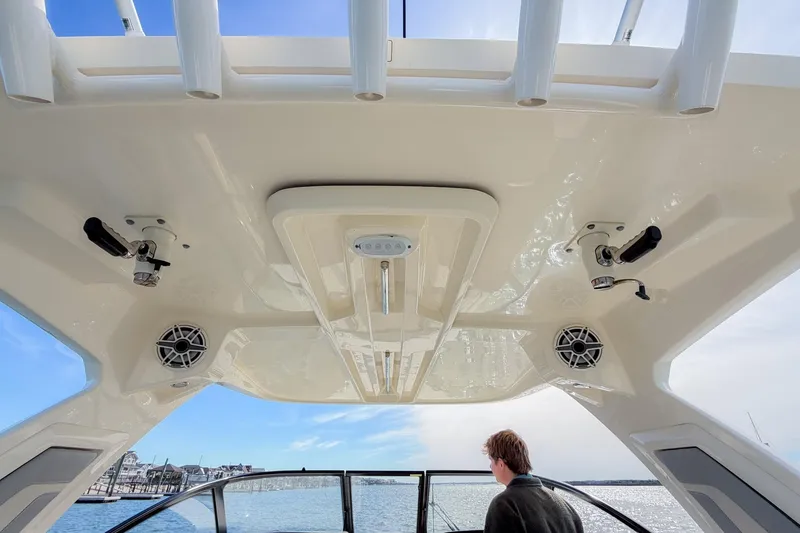 Slide: The Image of 2023 Scout 277 Dorado boat interior with speakers and fishing rod holders. - 11