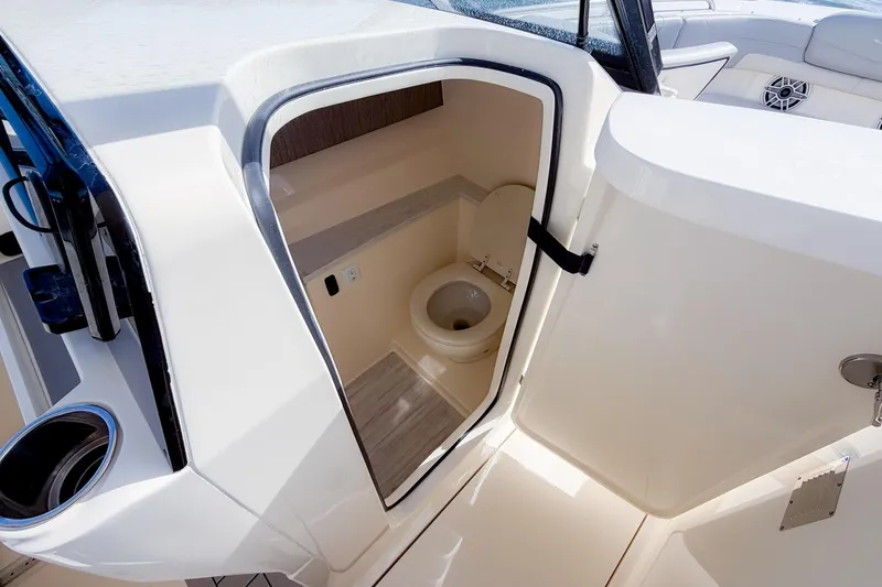 Slide: The Image of Interior view of 2023 Scout 277 Dorado boat's compact bathroom area. - 18