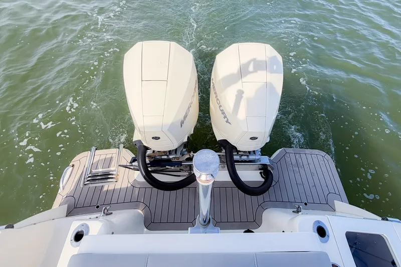 Slide: The Image of 2023 Scout 277 Dorado boat with dual Mercury outboard engines on water. - 21