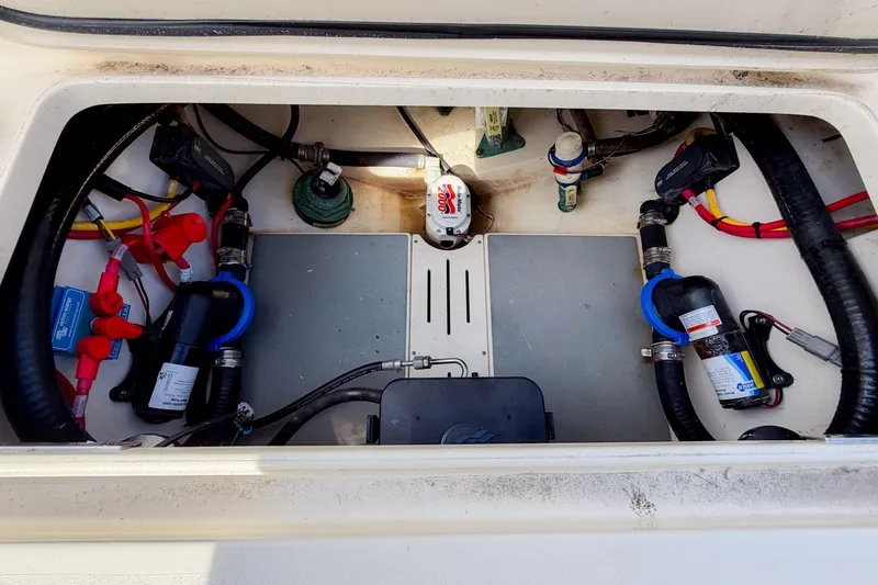 Slide: The Image of 2023 Scout 277 Dorado boat engine compartment with wiring and components. - 23