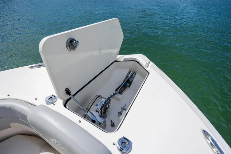 Slide: The Image of Open anchor compartment on 2023 Scout 277 Dorado boat, near water. - 29