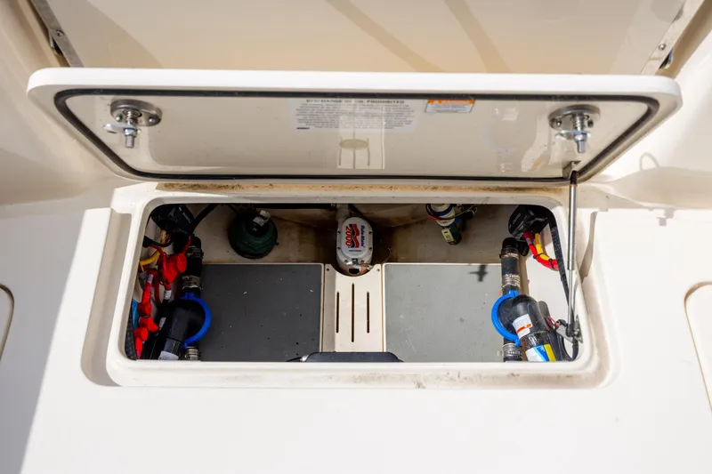 Slide: The Image of Open hatch of 2023 Scout 277 Dorado boat showing internal components and wiring. - 34