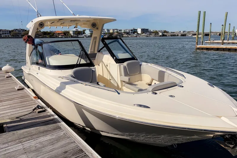 Slide: The Image of 2023 Scout 277 Dorado boat docked by the water on a sunny day. - 8