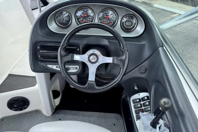 Slide: The Image of 2005 Centurion Elite V-Drive boat dashboard with steering wheel and gauges. - 10