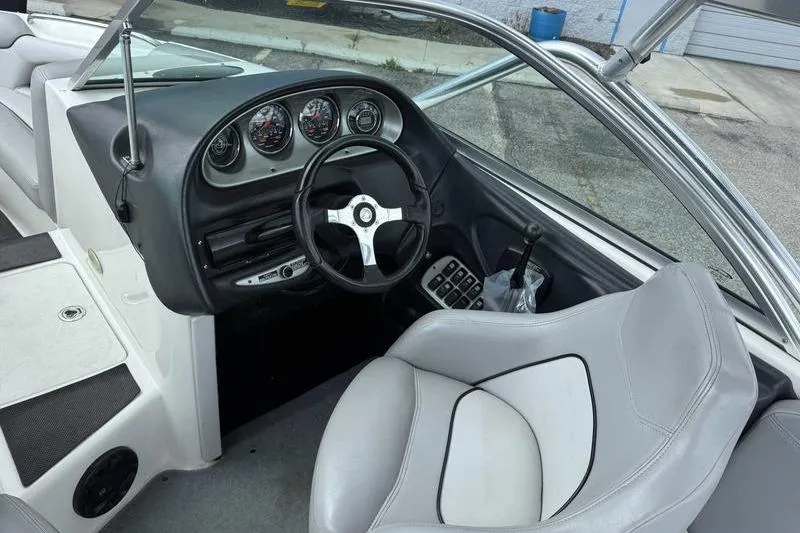 Slide: The Image of 2005 Centurion Elite V-Drive boat interior with steering wheel and dashboard controls. - 11