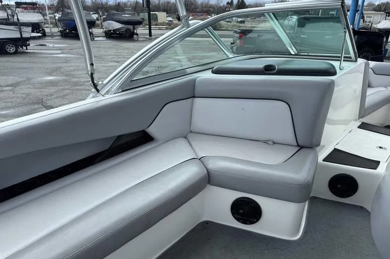 Slide: The Image of 2005 Centurion Elite V-Drive boat interior with gray seating and speakers. - 12