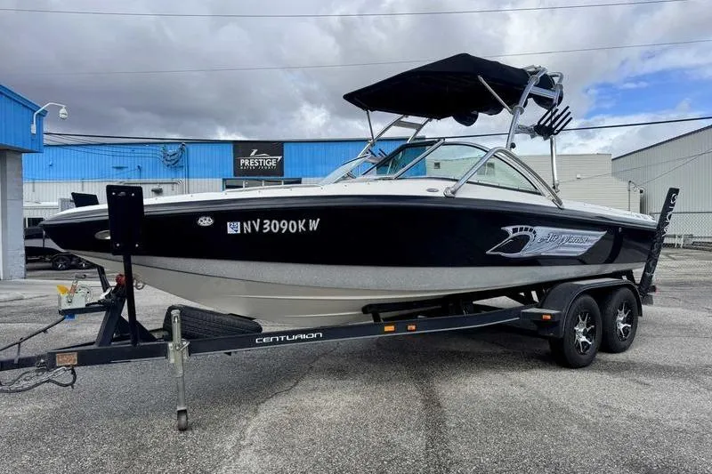 Slide: The Image of 2005 Centurion Elite V-Drive boat on trailer, parked outdoors under cloudy sky. - 4