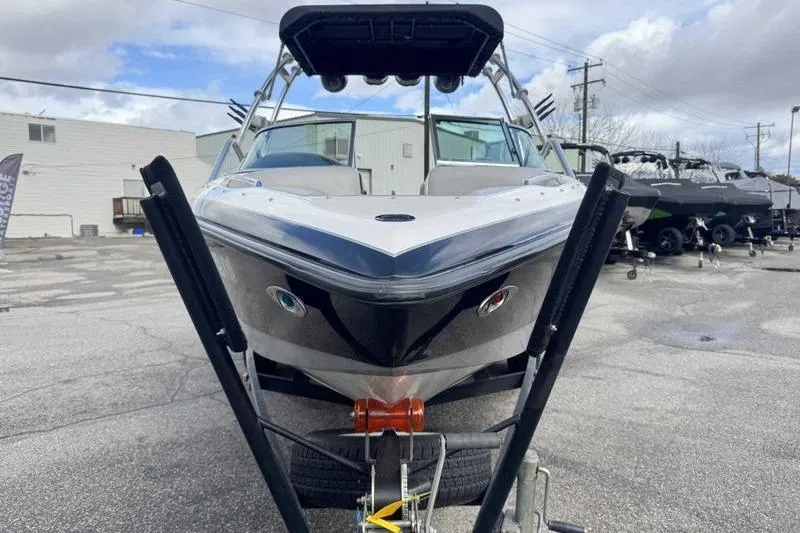 Slide: The Image of 2005 Centurion Elite V-Drive boat on trailer, parked outdoors under cloudy sky. - 6