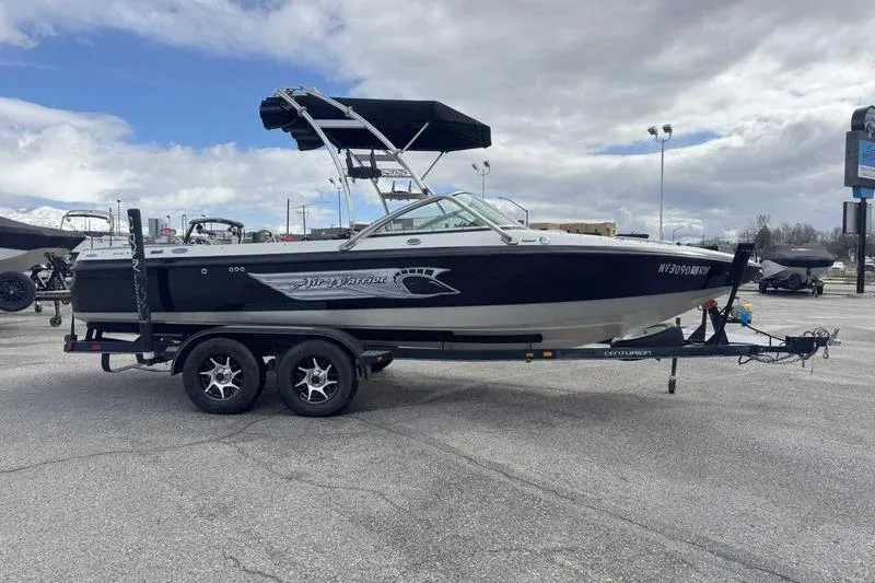 Slide: The Image of 2005 Centurion Elite V-Drive boat on trailer under cloudy sky. - 7