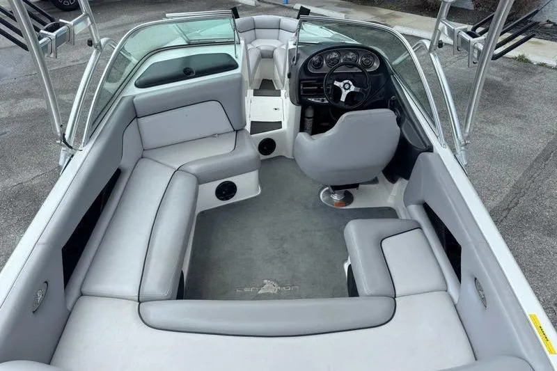 Slide: The Image of 2005 Centurion Elite V-Drive boat interior with gray seating and steering console. - 9