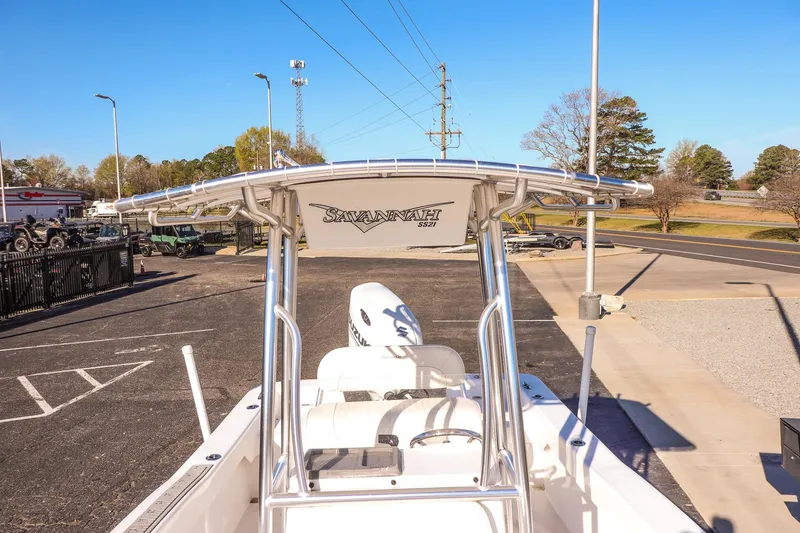 Slide: The Image of 2022 Savannah SS21 boat with T-top, parked outdoors on a sunny day. - 10