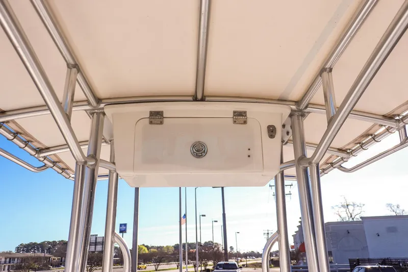Slide: The Image of T-top view of 2022 Savannah SS21 boat, showcasing sturdy metal framework and storage compartment. - 11