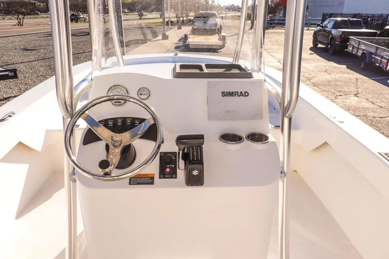 Slide: The Image of 2022 Savannah SS21 boat console with steering wheel and Simrad navigation system. - 12