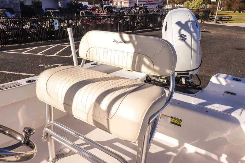 Slide: The Image of Savannah SS21 2022 boat seat with Suzuki engine in a parking lot setting. - 14