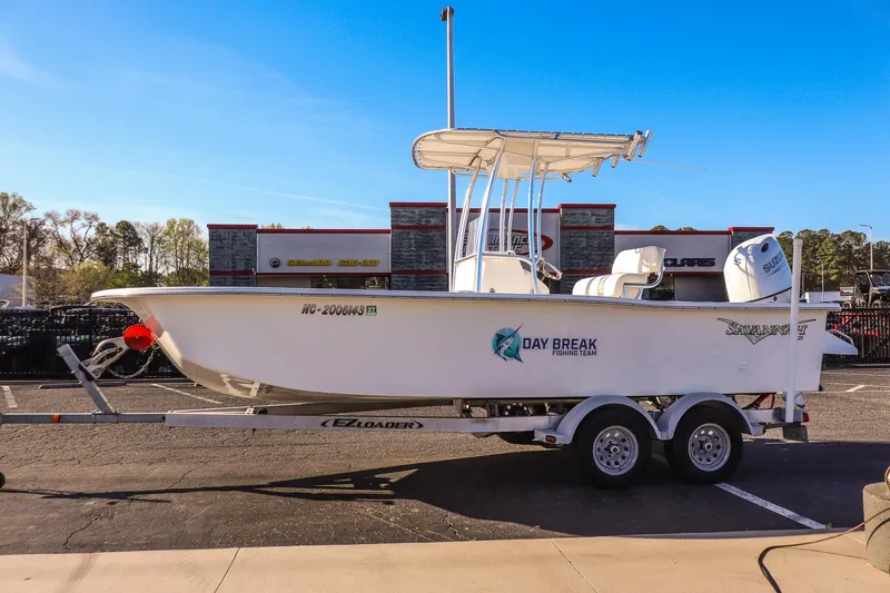 Slide: The Image of 2022 Savannah SS21 fishing boat on trailer in parking lot, clear blue sky. - 5