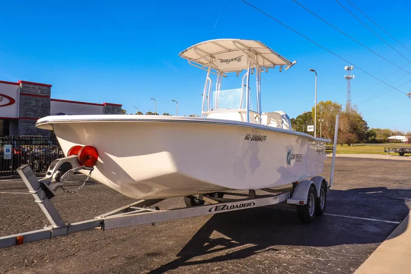 Slide: The Image of 2022 Savannah SS21 boat on trailer in parking lot under clear blue sky. - 6