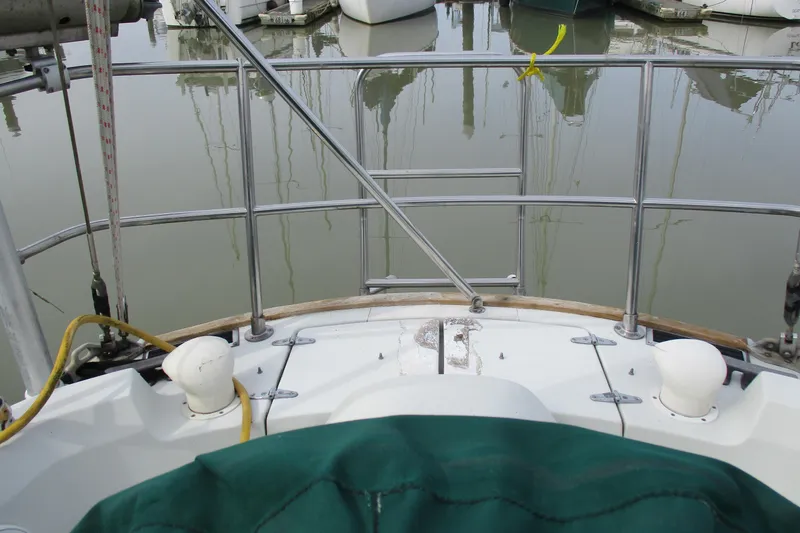 Slide: The Image of 1981 C & C 32 sailboat stern view with marina reflections. - 10