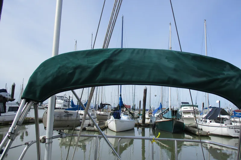 Slide: The Image of 1981 C & C 32 sailboat docked in a marina with green canopy. - 11
