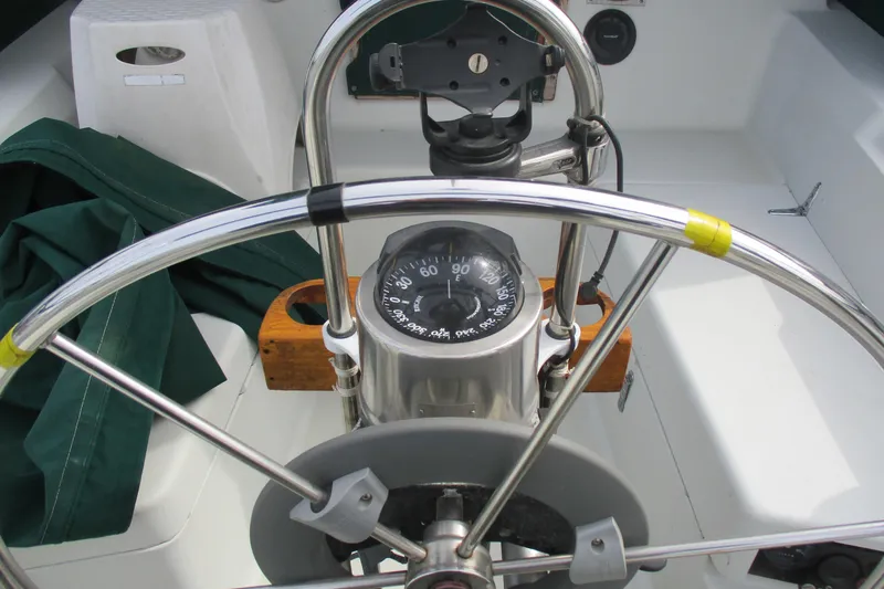 Slide: The Image of Steering wheel and compass of a 1981 C & C 32 sailboat cockpit. - 12