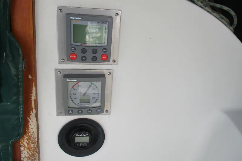 Slide: The Image of Raymarine autopilot and wind instruments on 1981 C & C 32 sailboat dashboard. - 14