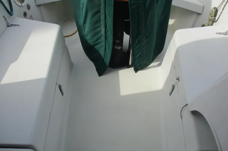 Slide: The Image of Cockpit of 1981 C & C 32 sailboat with green cover and storage compartments. - 16
