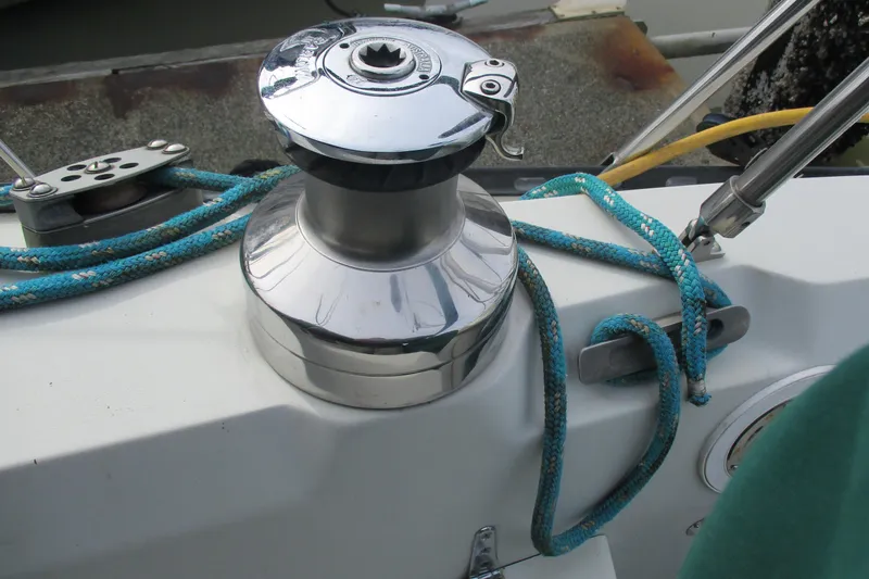 Slide: The Image of Chrome winch on 1981 C & C 32 sailboat with blue rope coiled around it. - 18