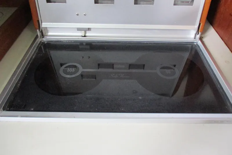 Slide: The Image of Built-in stove on 1981 C & C 32 sailboat, featuring a sleek black glass surface. - 23