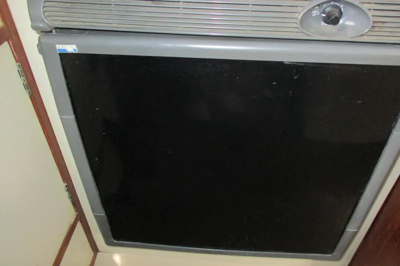 Slide: The Image of 1981 C & C 32 model refrigerator with black door and control knob. - 24