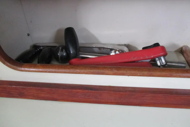 Slide: The Image of Tools stored in a wooden compartment on a 1981 C & C 32 sailboat. - 26