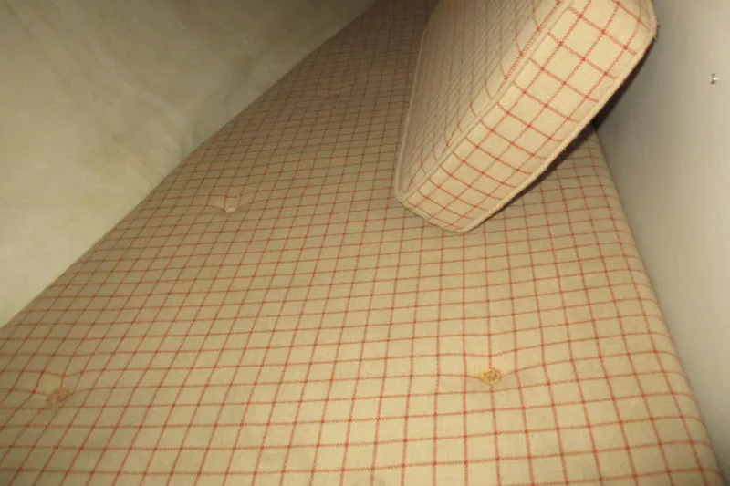 Slide: The Image of Plaid-patterned cushion on 1981 C & C 32 sailboat interior. - 27