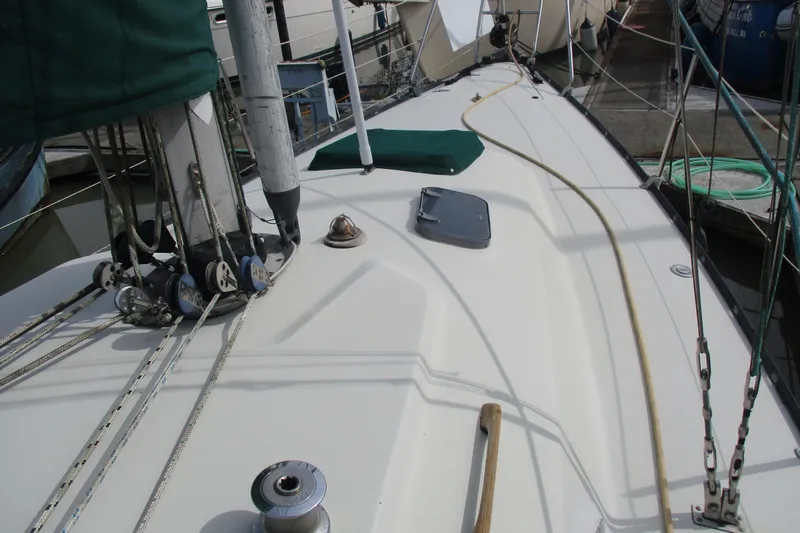 Slide: The Image of 1981 C & C 32 sailboat deck with rigging and winch, docked at marina. - 3