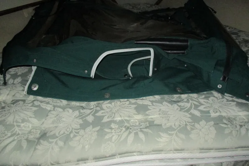 Slide: The Image of Green canvas cover for 1981 C & C 32 sailboat on floral-patterned mattress. - 38