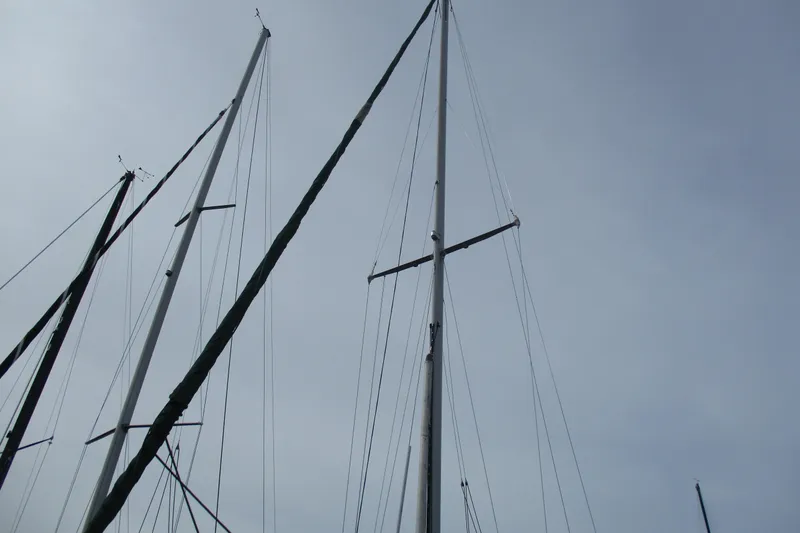 Slide: The Image of Tall masts of a 1981 C & C 32 sailboat against a cloudy sky. - 6