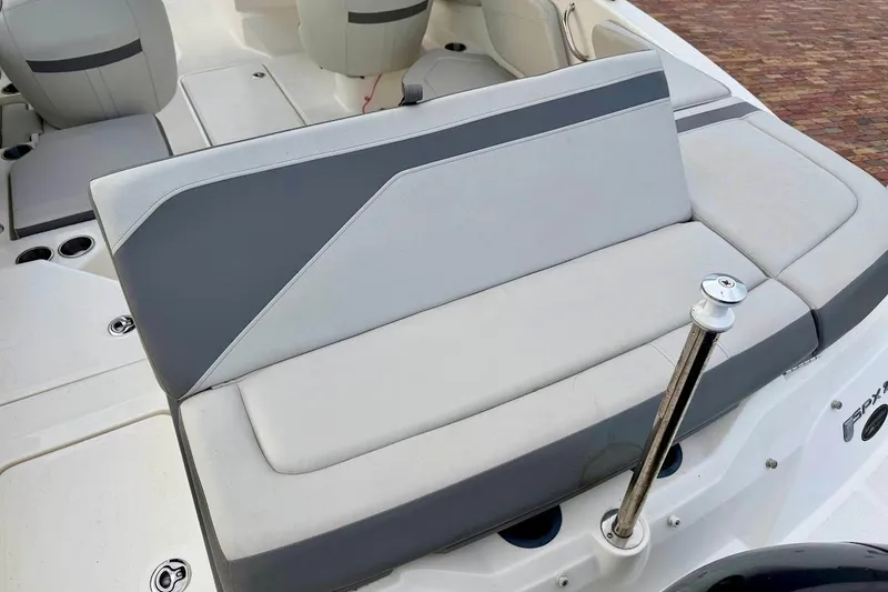 Slide: The Image of 2020 Sea Ray SPX 210 Outboard boat interior with gray and white seating. - 14