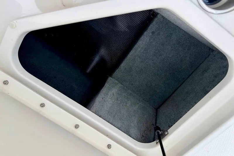 Slide: The Image of Storage compartment of a 2020 Sea Ray SPX 210 Outboard boat, featuring a clean interior. - 18