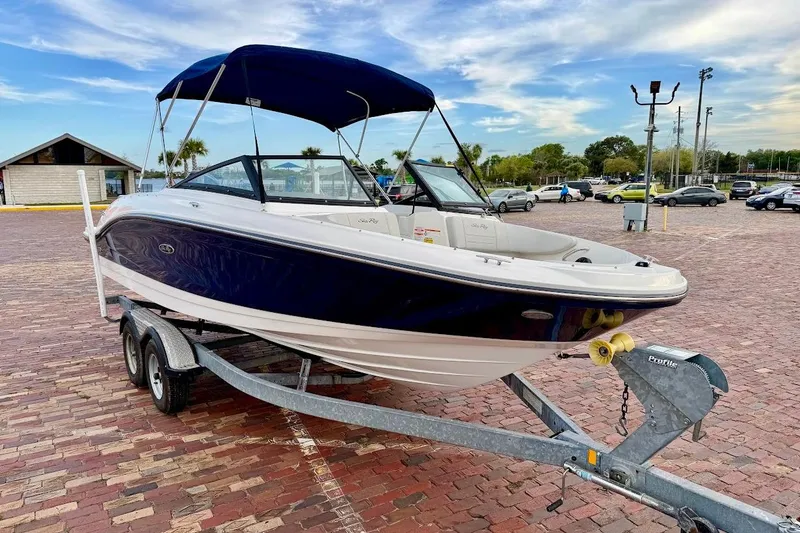 Slide: The Image of 2020 Sea Ray SPX 210 Outboard boat on trailer in parking lot. - 2