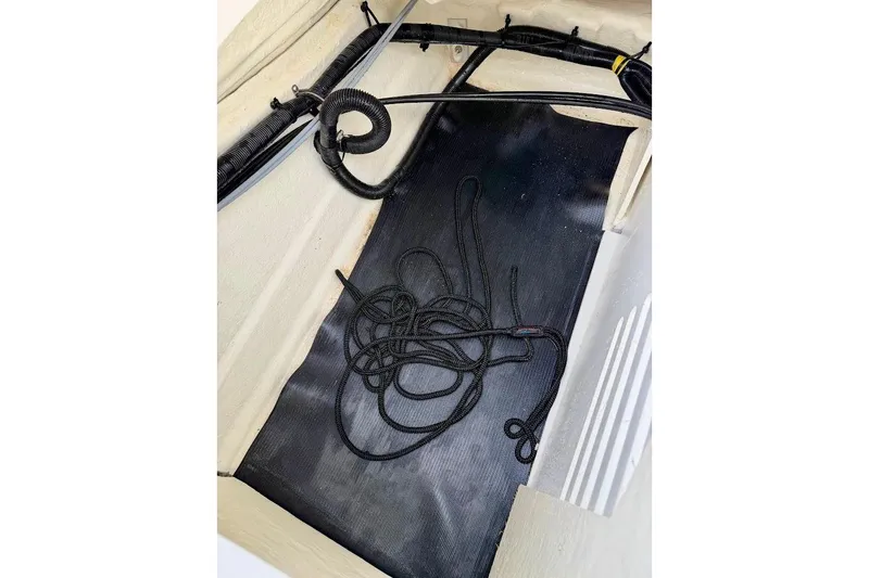 Slide: The Image of Storage compartment of 2020 Sea Ray SPX 210 Outboard with coiled rope. - 20