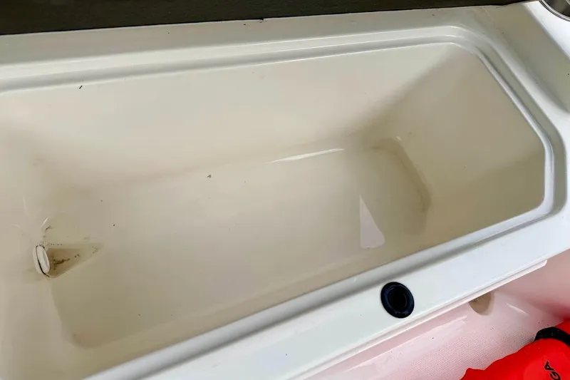 Slide: The Image of Storage compartment in 2020 Sea Ray SPX 210 Outboard boat, featuring a clean interior. - 21