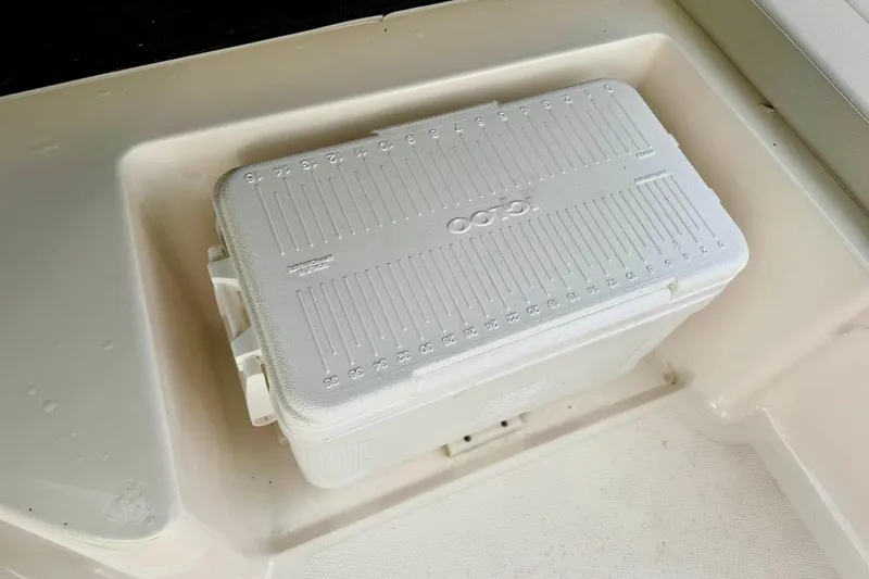 Slide: The Image of White cooler in a 2020 Sea Ray SPX 210 Outboard boat compartment. - 23
