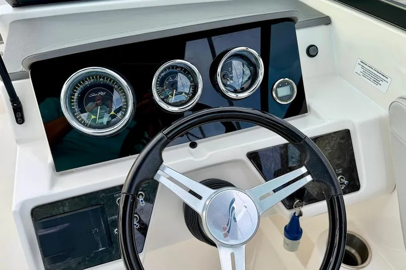 Slide: The Image of Dashboard of 2020 Sea Ray SPX 210 Outboard boat with steering wheel and gauges. - 31